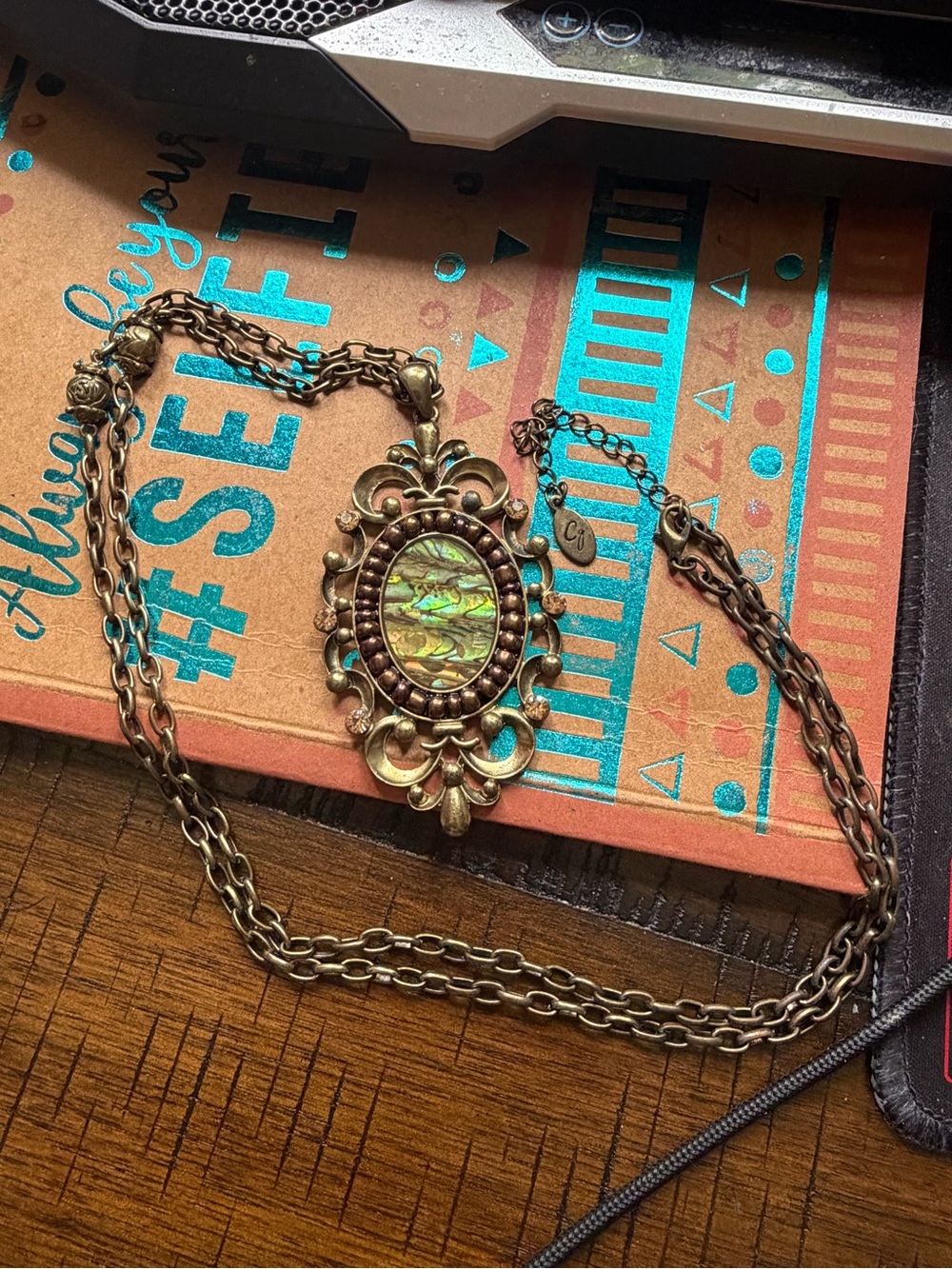 Antique-Style Bronze Filigree Pendant Necklace with Iridescent Abalone Inlay